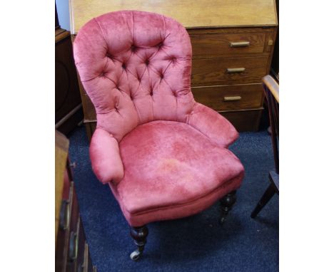 A Victorian mahogany button back nursing chair, turned forelegs, ceramic casters. 