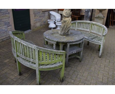 A garden table with four nested chairs; two arced garden benches. (7)