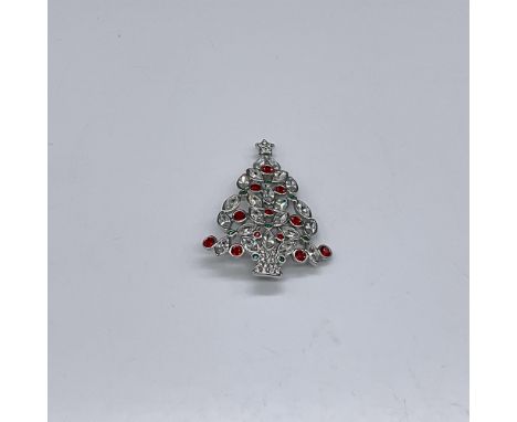 Annual edition Christmas Tree Brooch from 2002. Red, green, and white crystals are set in silver. This item has its original 
