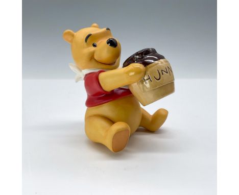 Ceramic figure from Disney's Winnie the Pooh and the Honey Tree, depicting Pooh lifting a Honey Pot to enjoy the honey. Issue