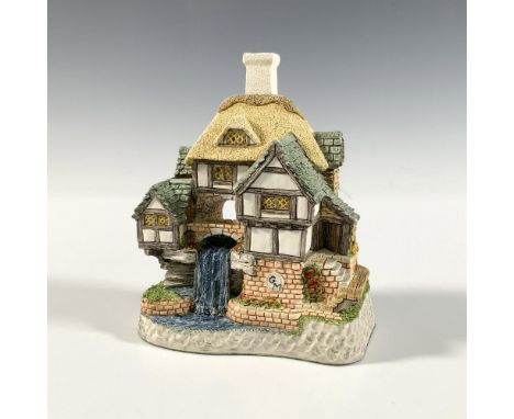 This beautiful warm intricate cottage figurine was made in 1997 out of ceramic and porcelain material. Hand made and hand pai