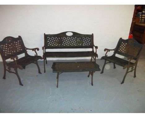 A CAST IRON FOUR PIECE GARDEN BENCH SET