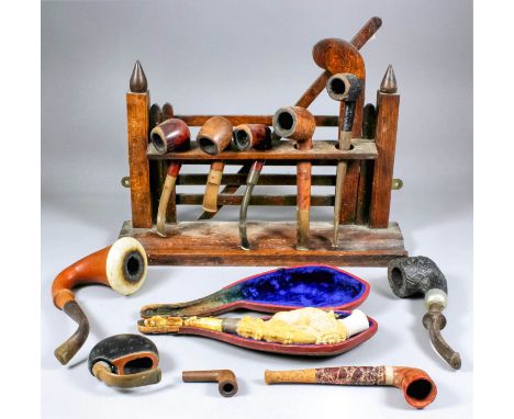 A collection of eleven pipes, and an oak novelty rack in the form of a four-bar gate, including - a silver mounted Meerschaum