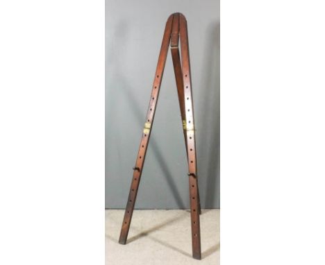 An artist's mahogany three part folding easel, 74.75ins x 7.25ins x 0.75ins (folded)