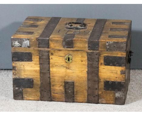 An 18th Century pine and metal bound trunk, the lid with studded initials "I.F." and dated 1789, with plain steel straps and 