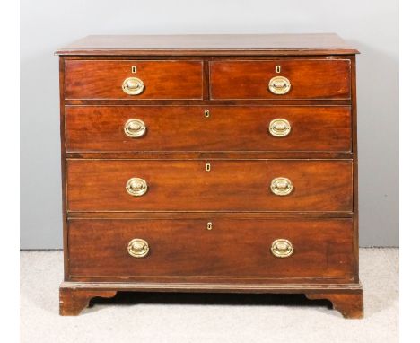 A late George III mahogany chest, the top crossbanded and with moulded edge, fitted two short and three long drawers, the bra