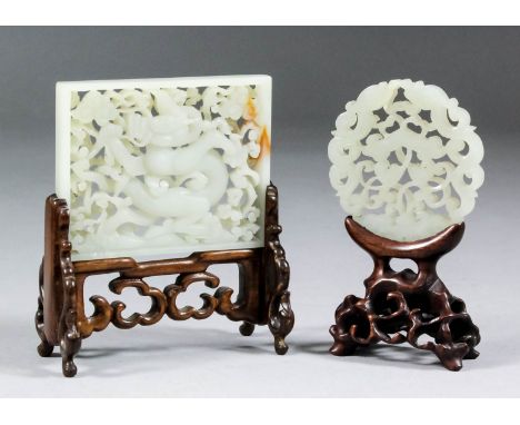 A Chinese pale celadon jade rectangular plaque, pierced and carved with a dragon amongst clouds, 2.25ins (5.7cm) x 3ins (7.6c
