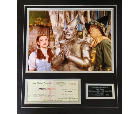 Jack Haley 19x17 inch overall mounted signature display includes signed cheque , colour photo from the Wizard of Oz and name 