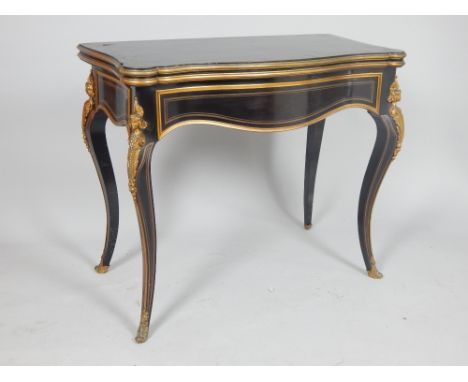 19th century French Empire style ebony and brass inlaid card table, the serpentine rectangular top above gilt metal mounts an