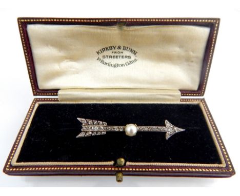 Art Deco diamond set arrow brooch with central pearl, the old cut diamonds mounted in white and yellow gold, unmarked