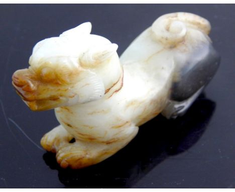 Chinese antique carved 'mutton fat' jade model of a temple dog, circa late 18th C / early 19th C, 4cm h, 7cm l