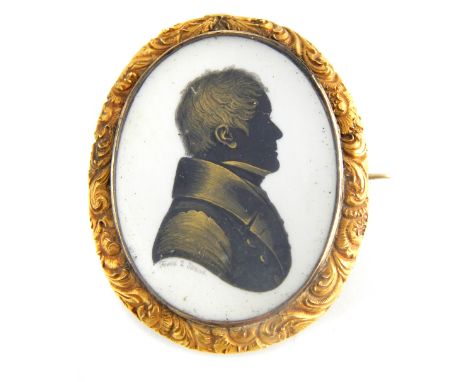 John Field, a Regency bronzed silhouette memento mori brooch on ivory depicting a head and shoulder portrait of a gentleman, 