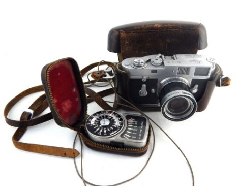 Leica M2 camera c.1959, no.961165, fitted with a Leitz Wetzlar f=50mm 1:2.8 lens with hood, in a brown leather case and a Wes