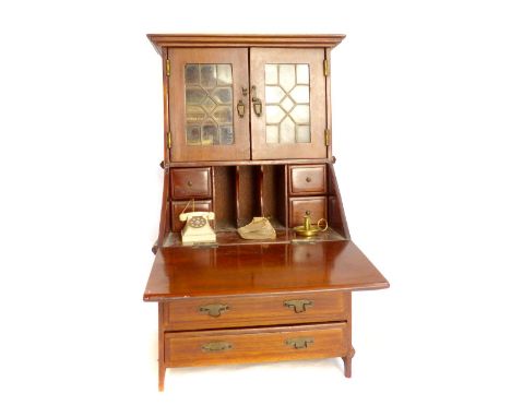 Apprentice furniture piece, miniature bureau bookcase, c.1911, lead light double glazed doors with miniature books, mahogany 