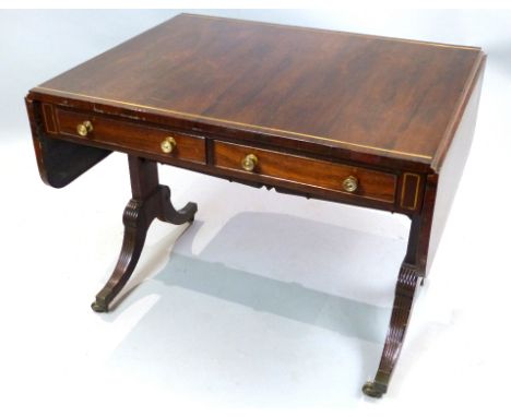 Regency brass inlaid rosewood sofa table with rectangular twin flap top over two drawers on solid end standards with fluted d