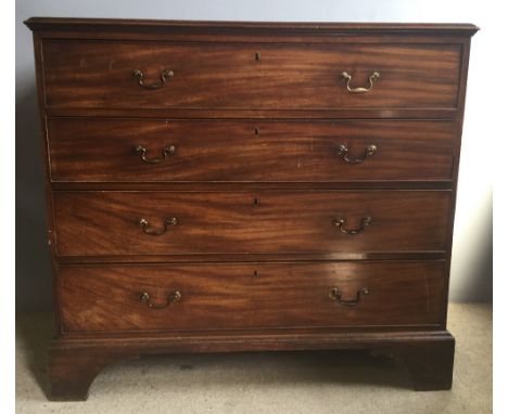 A George III mahogany chest of drawers, the moulded rectangular top above four graduated drawers with brass handles, standing