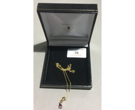 A gold and amethyst pendant on a 9 ct gold chain