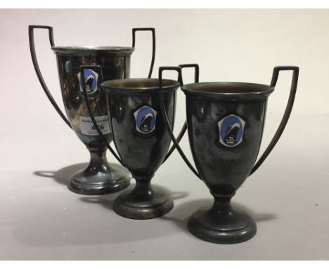 Three silver plated trophies, each with Holland America Line enamel logo