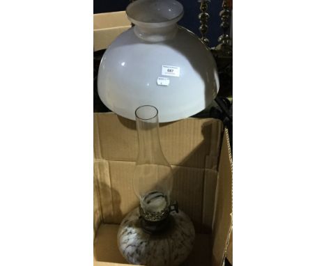 An oil lamp, two hanging lamp frames and a milk glass shade