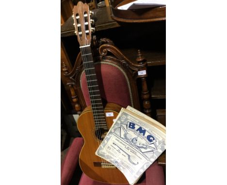 An acoustic guitar with labels for Jacques Camurat, Paris dated 1972 and Pamplona, Luthier a Paris