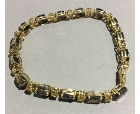 A 14 K gold citrine and smoky quartz bracelet