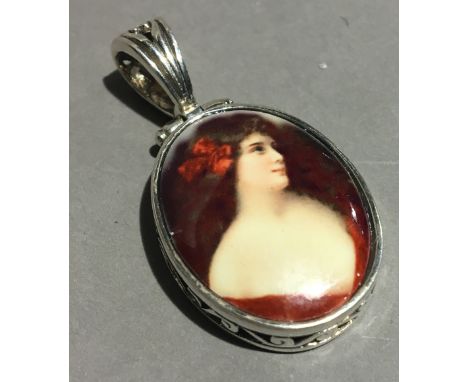 A silver pendant set with a miniature portrait