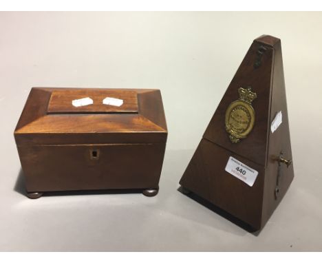 A 19th century walnut tea caddy together with a metronome in oak case, Maezel, London