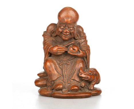 A CHINESE BAMBOO CARVING OF AN IMMORTAL V worked in light colour wood as a hermit seated on a rock, smiling, his long earlobe