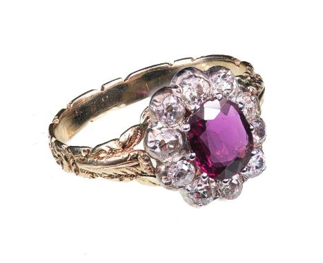 A 19TH CENTURY RUBY AND DIAMOND CLUSTER RING unmarked, the oval cut ruby, within a border of ten old cut diamonds. Estimated 