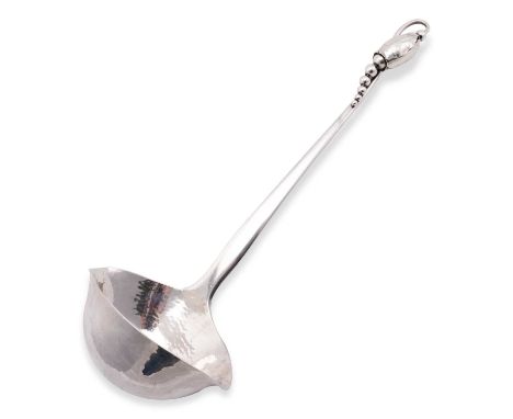 GEORG JENSEN: A DANISH STERLING SILVER LADLE no. 84, Blossom pattern, lightly planished body with a magnolia blossom finial. 