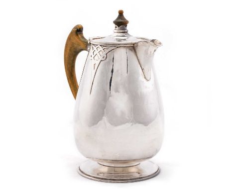 A SCOTTISH SILVER HOT WATER JUG maker J.S.H., Edinburgh 1977, the ovoid body with knotwork motifs. 19.5cm high, 15.8 troy oun