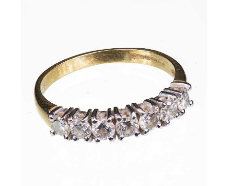 AN 18 CARAT YELLOW GOLD AND DIAMOND SEVEN STONE RING set with round brilliant-cut diamonds. Estimated total diamond weight 0.