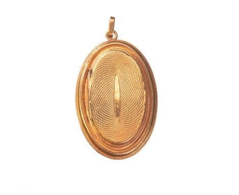 A LATE VICTORIAN GOLD LOCKET PENDANT unmarked, oval, with an engine-turned hinged front. 4.3cm high (incl. bail), 8.4 grams g