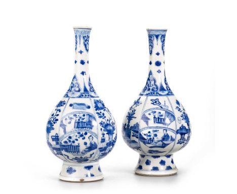 TWO CHINESE BLUE AND WHITE PORCELAIN BOTTLE VASES, KANGXI PERIOD each vase of pear-form and raised on a tall, spreading foot,