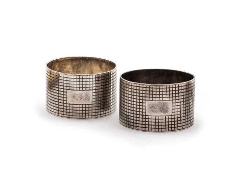 A PAIR OF ELIZABETH II SILVER NAPKIN RINGS by S J Rose &amp; Son, London 1958, both circular, with a cross hatch design and v