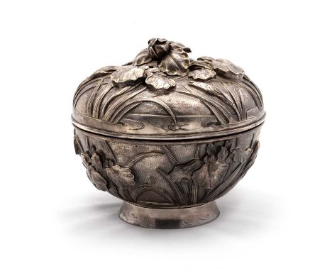 A JAPANESE SILVER BOX AND COVER Meiji period, boldly repoussé with iris, the cover with an applied flower finial, signed. 13c