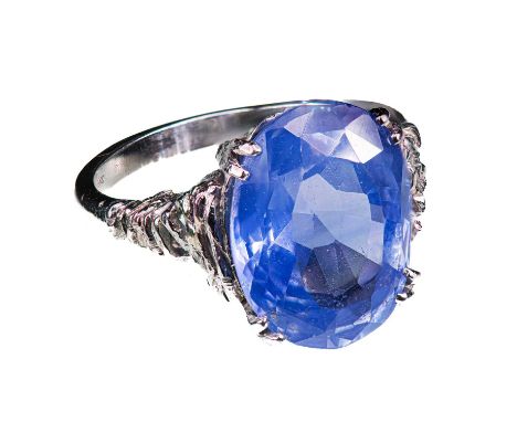 A NATURAL CEYLON SAPPHIRE RING, EST. 10 CT. the oval mixed-cut sapphire claw-set in a 1970s platinum ring. Sapphire 15.25mm b