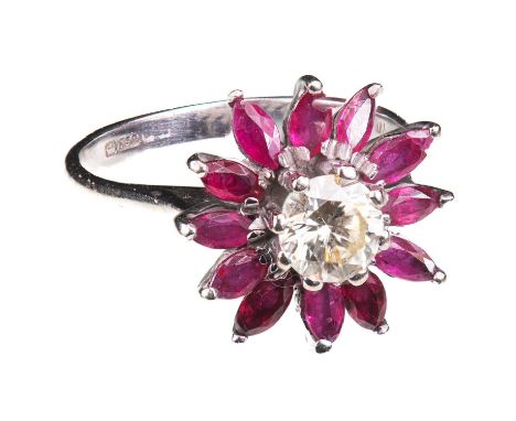 AN 18 CARAT WHITE GOLD, DIAMOND AND RUBY FLOWER HEAD CLUSTER RING stamped '18CT' and hallmarked '750', the central round whit