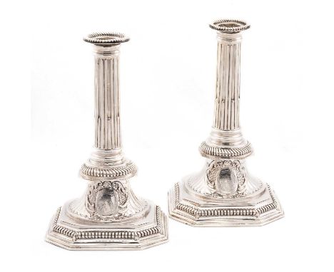 A PAIR OF QUEEN ANNE SILVER CANDLESTICKS by Richard Syng, London 1702, with slightly tapering stop-fluted columns above an em