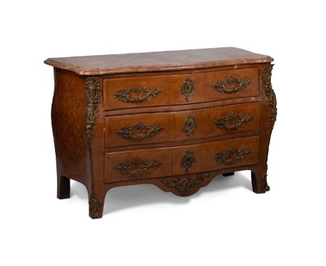 A LOUIS XV STYLE GILT-METAL MOUNTED AND MARBLE-TOPPED COMMODE of large proportions, of bombe form, the moulded serpentine top
