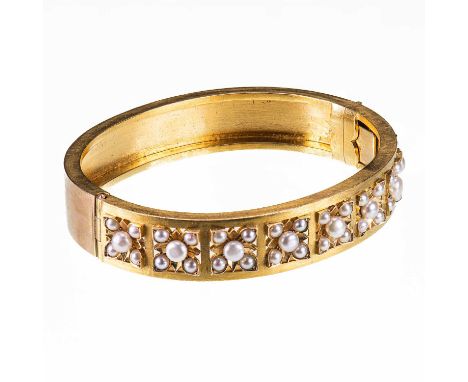 A LATE 19TH CENTURY PEARL HINGE OPENING BANGLE unmarked, the pierced front with pearl-set flower heads, to a plain hinge open