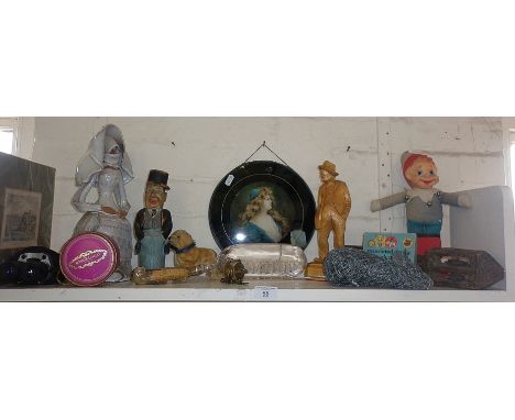 Shelf of assorted items including humorous painted carved figure etc