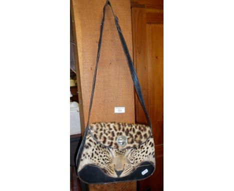 Vintage leather handbag with taxidermy face of leopard applied to body, circa 1930's