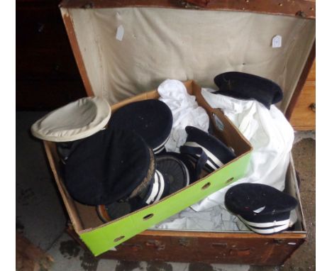Large collection of assorted naval caps and uniform in a trunk