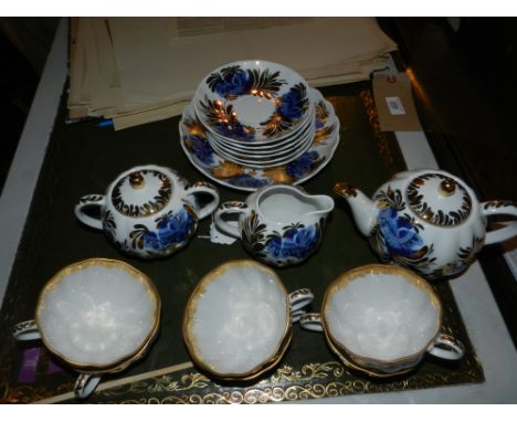 A Russian gilt and blue tea set, includes six cups, one tea pot, one sucriere, six saucers and one serving dish