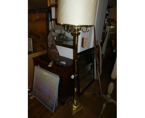 A four armed brass floor lamp, having stop-fluted stem on a stepped rectangular base