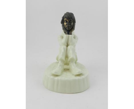 A Minton ceramic study of a seated boy, 'Spellbound'. H.13cm 