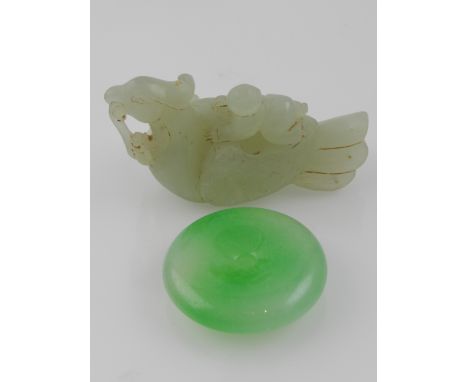 A Chinese jade paperweight in the form of a child upon a  mythical creature, together with a circular jade pendant 
