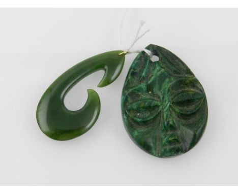 A malachite pendant carved with a face to front, together with one other jade pendant