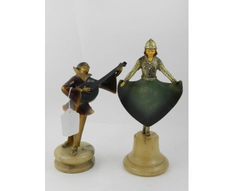 A pair of Art Deco style figurines, one depicting a man playing the mandolin, the other of a dancing woman  